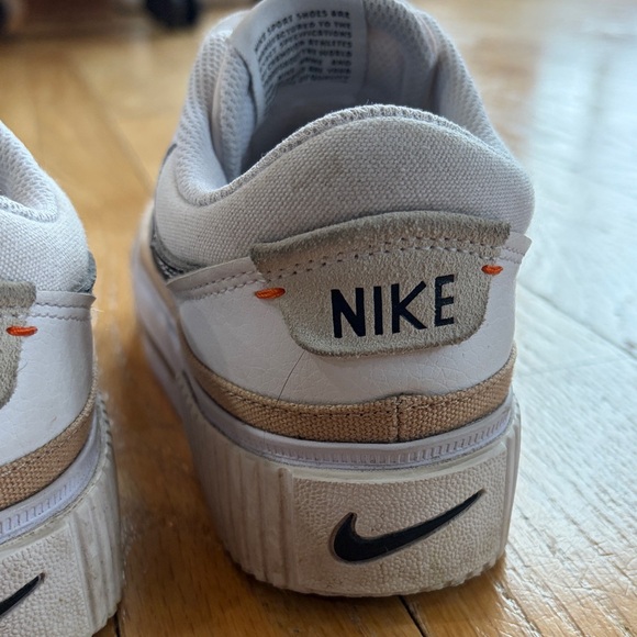 Nike White Low-Top Sneakers with Black Swoosh and Gold Accent - Picture 14 of 15